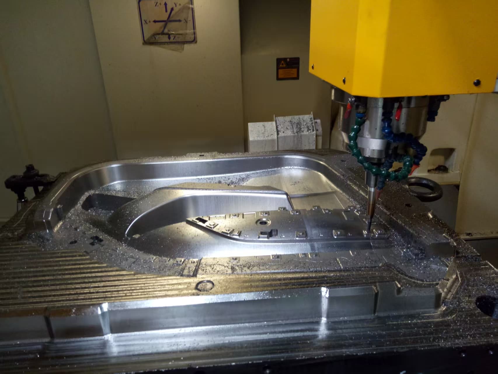 CNC machine machining a custom injection mold component